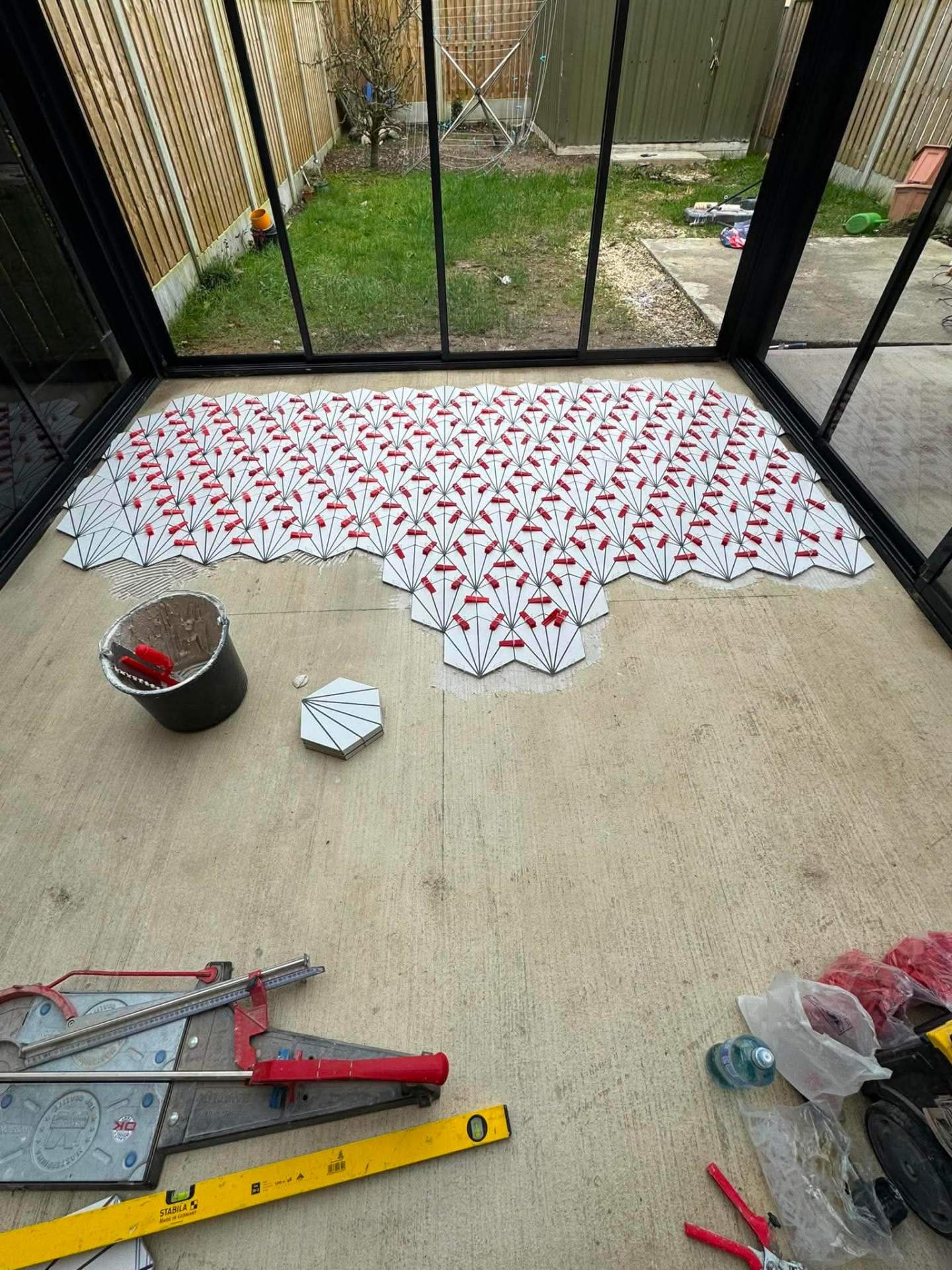 Patterned cement-look tile being set out