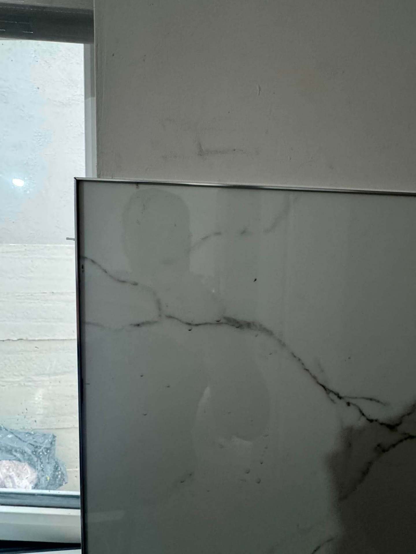 Glass screen against marble wall — finished
