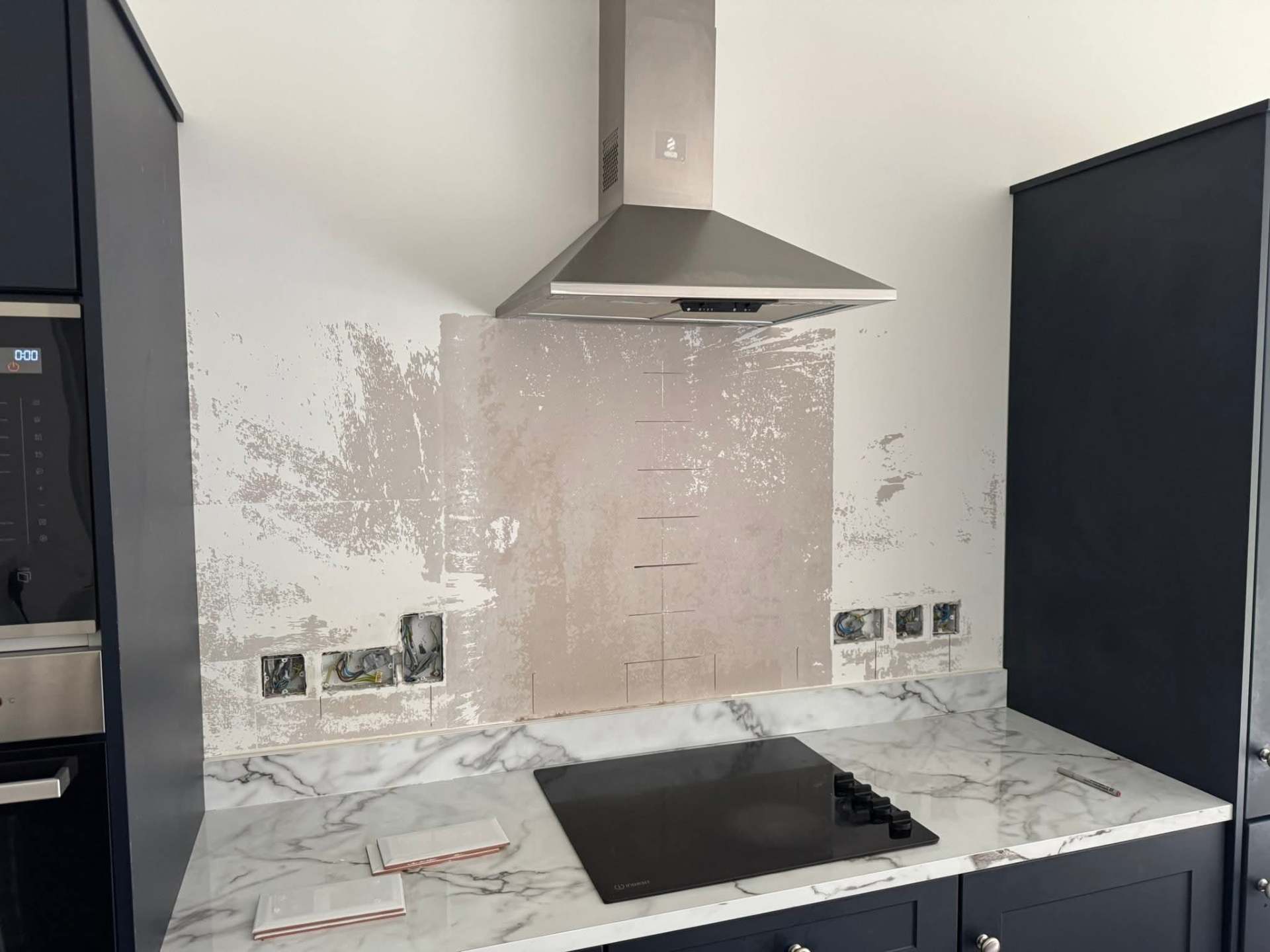 Chimney hood framed by fresh white metro tile