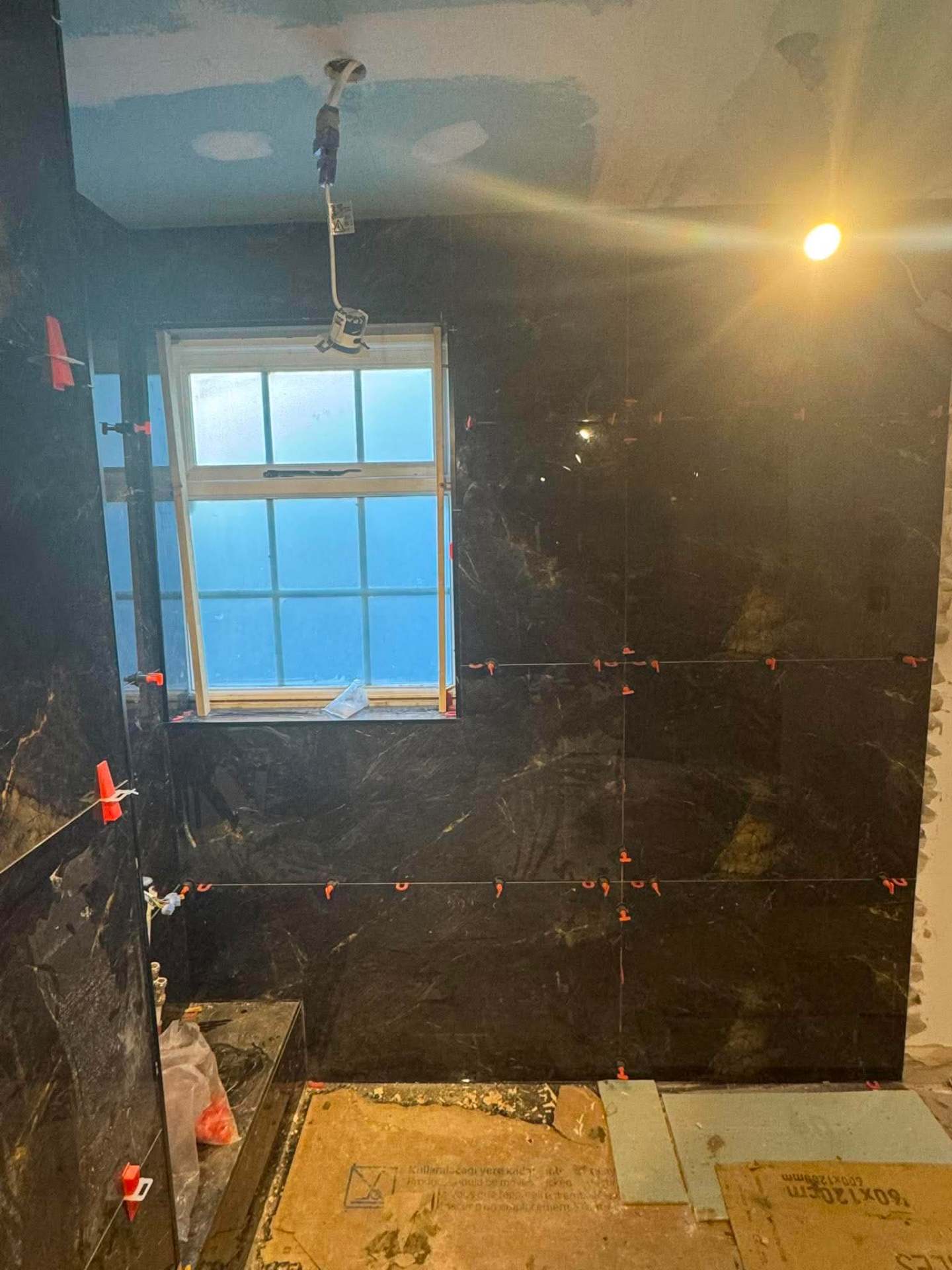 Stone-effect bathroom — shower head and wall