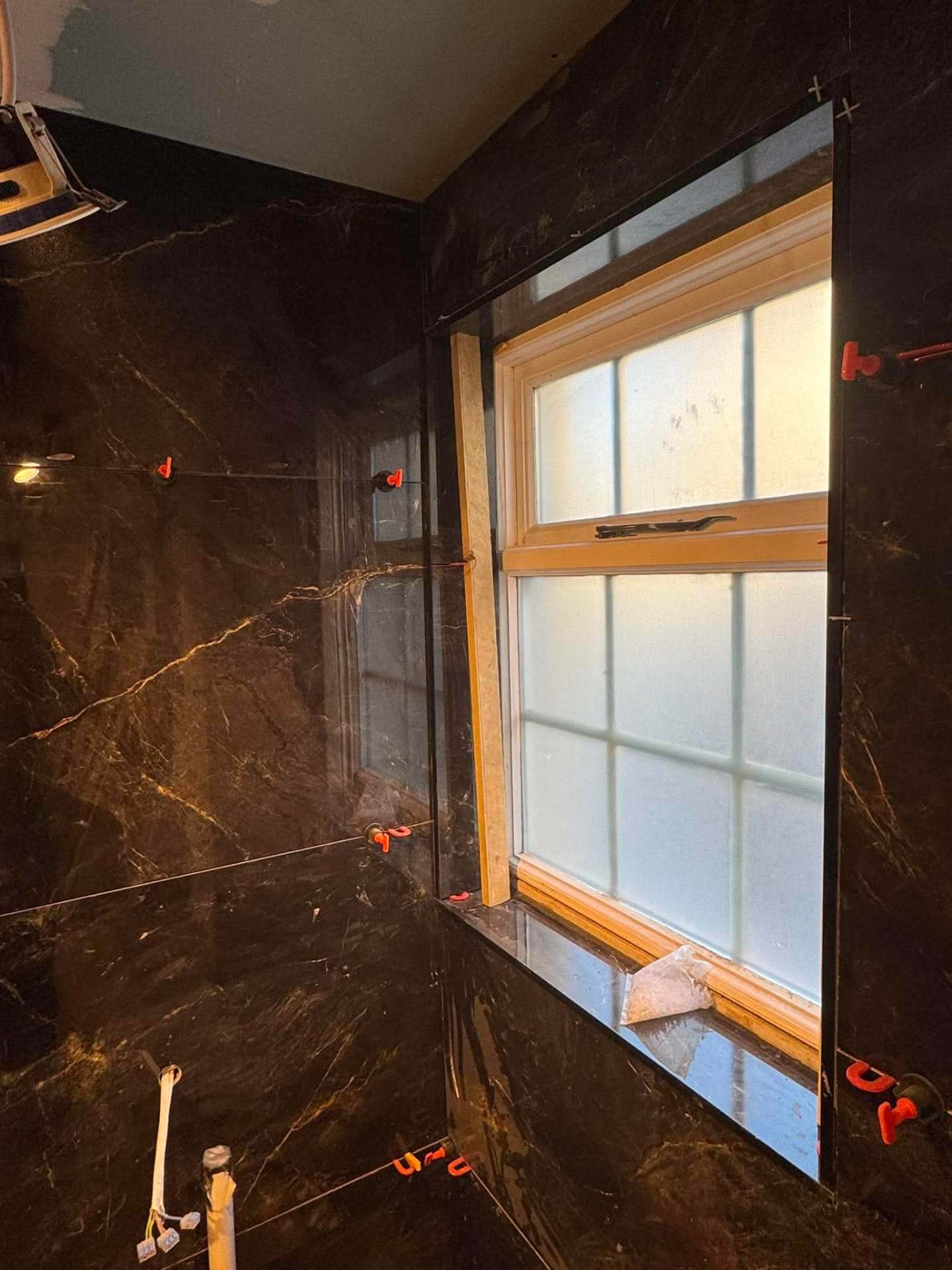 Dark marble bathroom — finished view with window