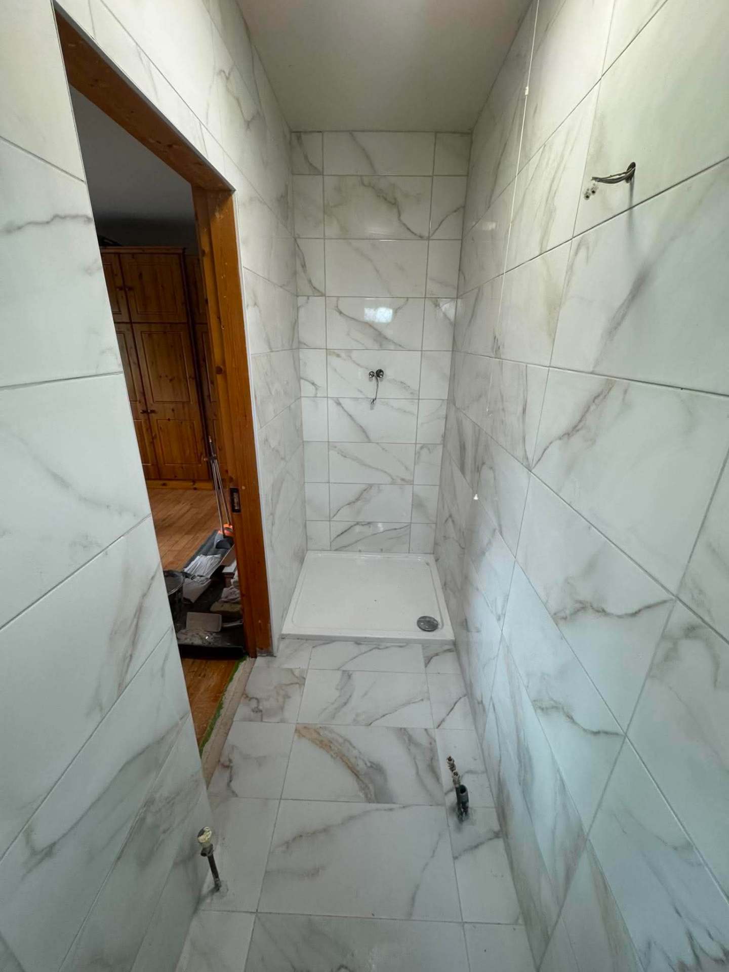 Calacatta marble shower — walls building up