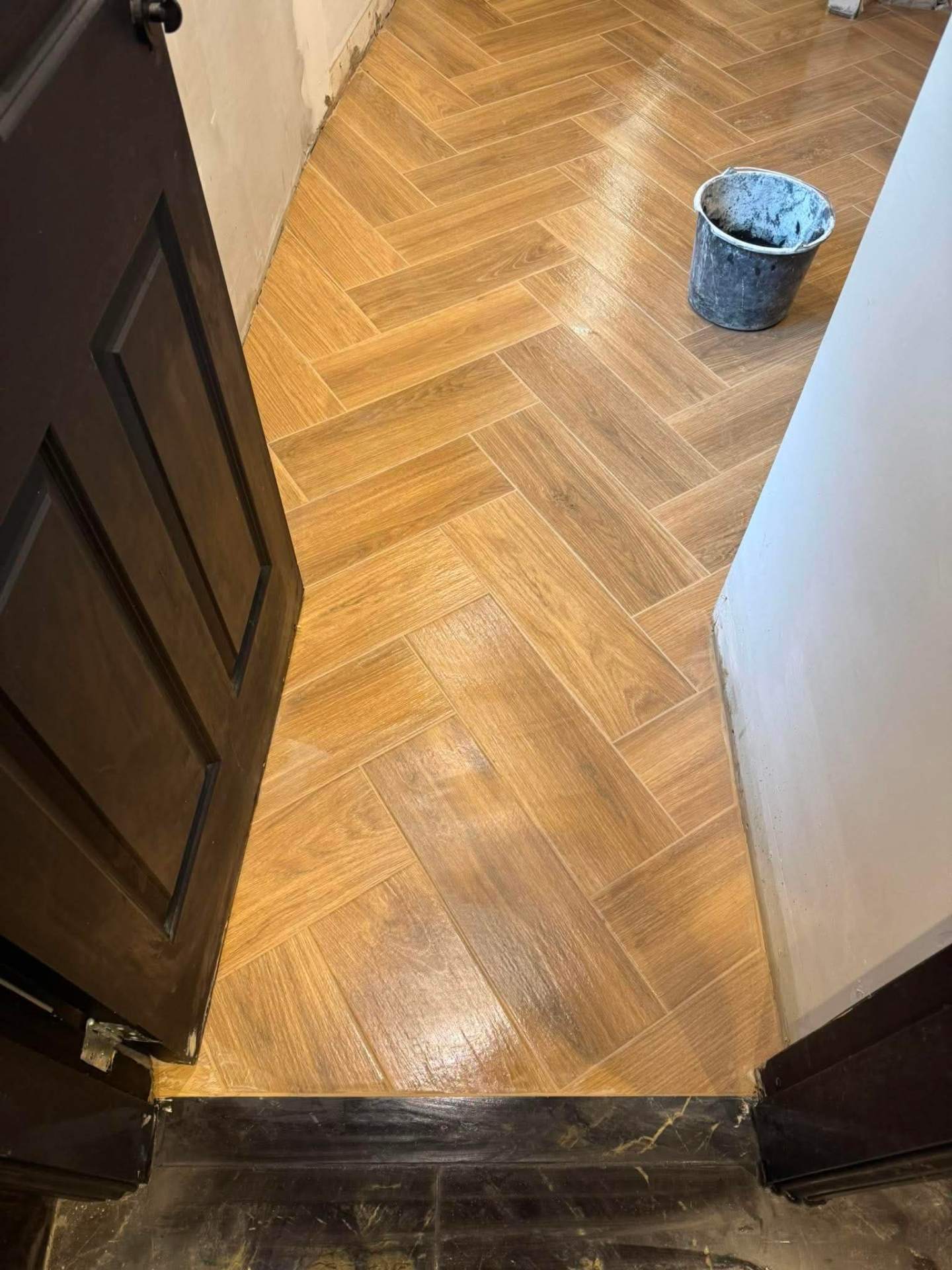Herringbone planks being set with clips
